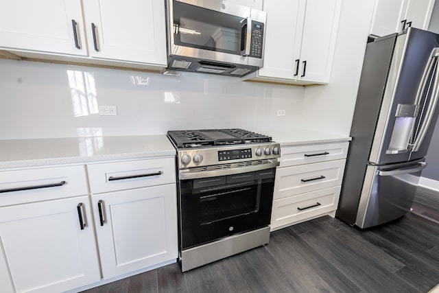 kitchen featuring appliances with stainless steel finishes, dark hardwood / wood-style floors, and white cabinetry