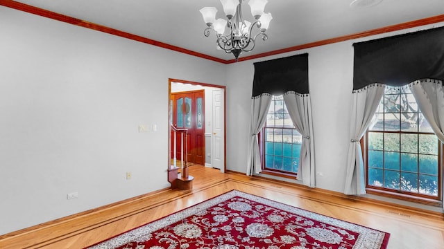 bedroom featuring visible vents, a notable chandelier, wood finished floors, and crown molding