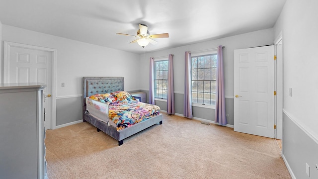 bedroom with visible vents, a ceiling fan, baseboards, and light carpet