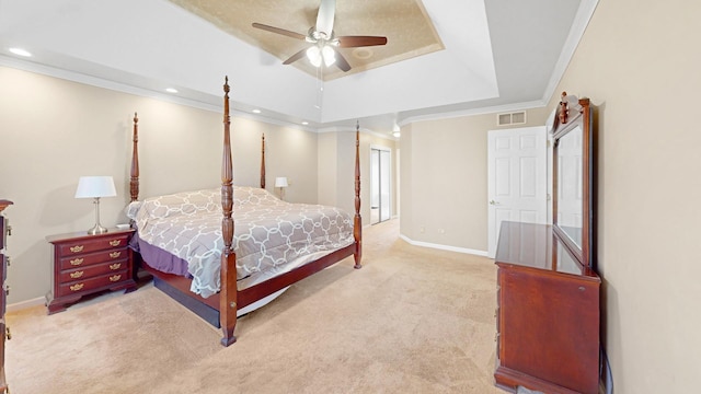 carpeted bedroom with visible vents, ornamental molding, a tray ceiling, recessed lighting, and baseboards