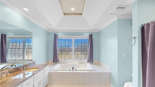 full bath featuring vanity, a tub with jets, visible vents, a tray ceiling, and ornamental molding