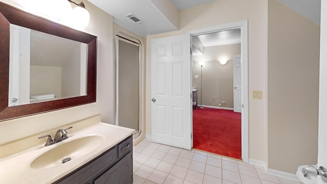 bathroom featuring visible vents, a stall shower, tile patterned flooring, baseboards, and vanity