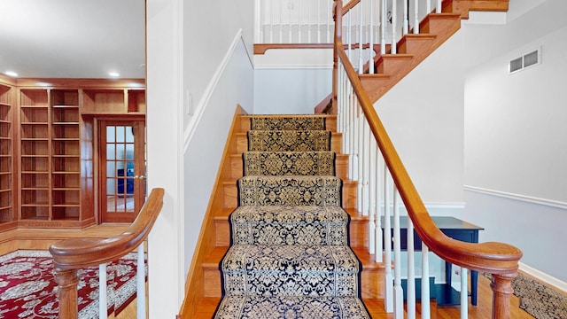 staircase featuring visible vents, recessed lighting, and wood finished floors