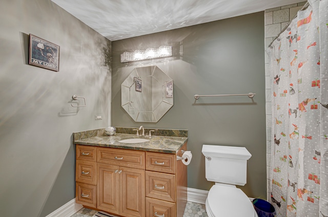 bathroom featuring tile patterned flooring, vanity, and toilet