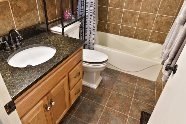 full bathroom with vanity, shower / bath combo, toilet, and tile patterned floors