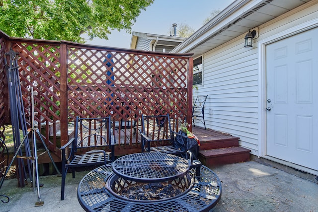 view of patio / terrace featuring a deck and a fire pit