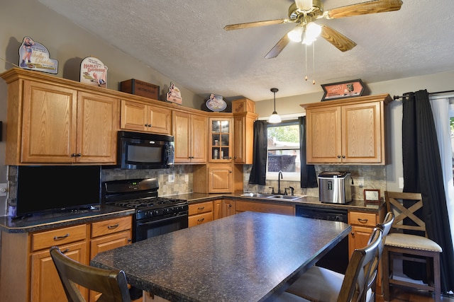 kitchen featuring a center island, black appliances, sink, and a breakfast bar area