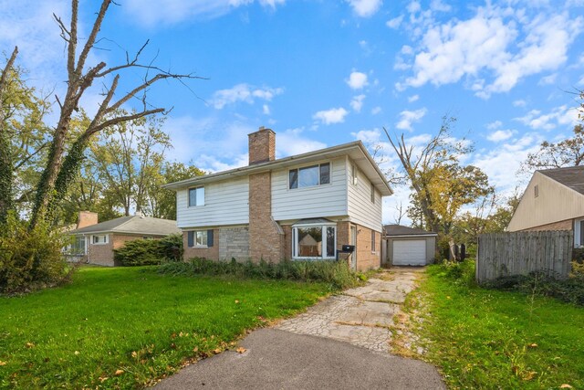 exterior space featuring a yard, a garage, a chimney, aphalt driveway, and an outdoor structure