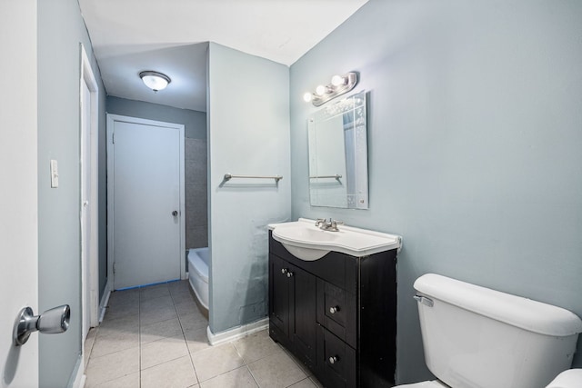 bathroom featuring a tub to relax in, toilet, tile patterned flooring, and vanity