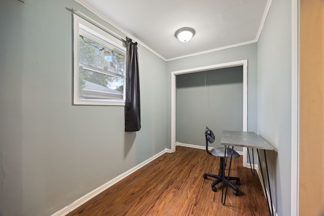 unfurnished office featuring dark wood-style flooring, ornamental molding, and baseboards