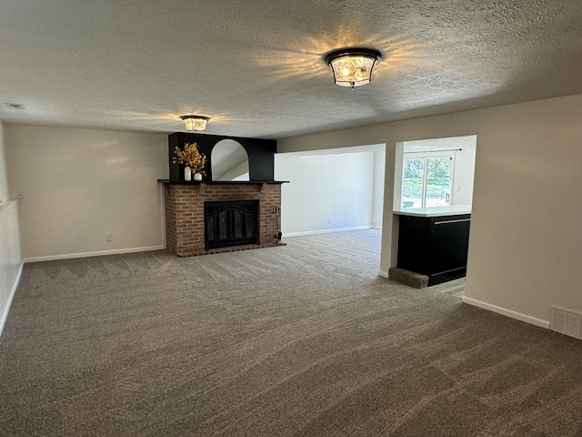 unfurnished living room featuring a textured ceiling, carpet flooring, and a brick fireplace