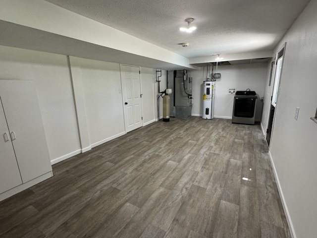 basement with washer / dryer, hardwood / wood-style floors, electric water heater, and a textured ceiling