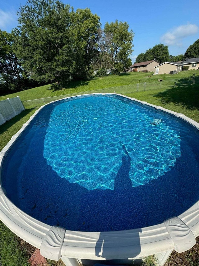 view of swimming pool featuring a lawn