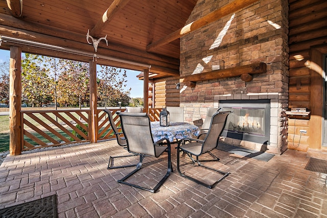 view of patio with an outdoor stone fireplace