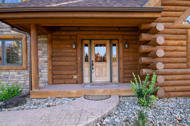 view of exterior entry with covered porch