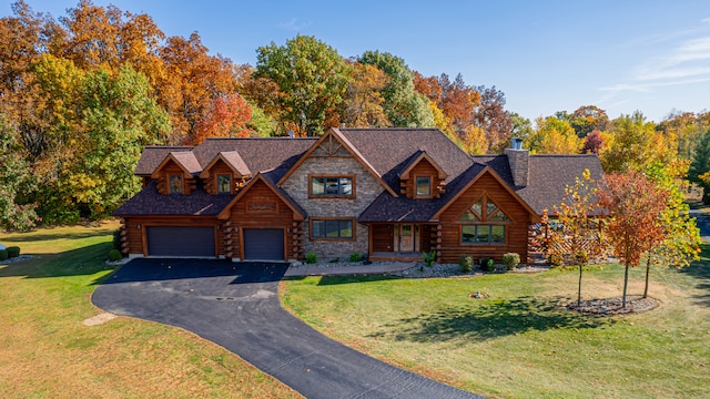 log-style house with a front lawn and a garage