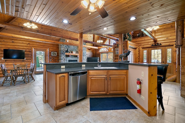 kitchen with log walls, stainless steel dishwasher, wooden ceiling, and a center island with sink