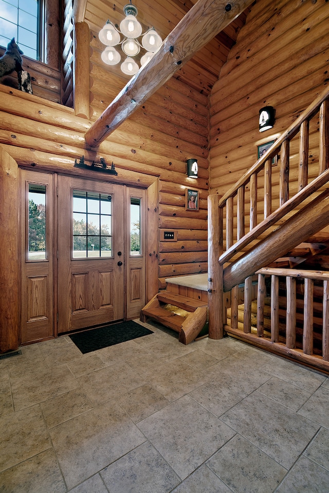 entrance foyer featuring log walls, beamed ceiling, and high vaulted ceiling