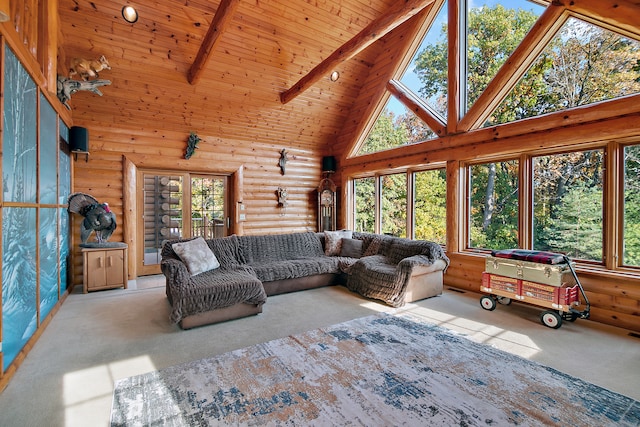 living room with beam ceiling, a wealth of natural light, light carpet, and high vaulted ceiling