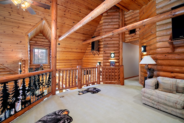 unfurnished room featuring wood ceiling, carpet floors, ceiling fan, beamed ceiling, and rustic walls