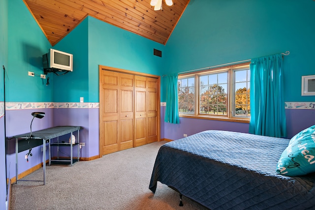 carpeted bedroom featuring a closet, high vaulted ceiling, and wooden ceiling