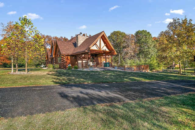 log-style house with a front lawn