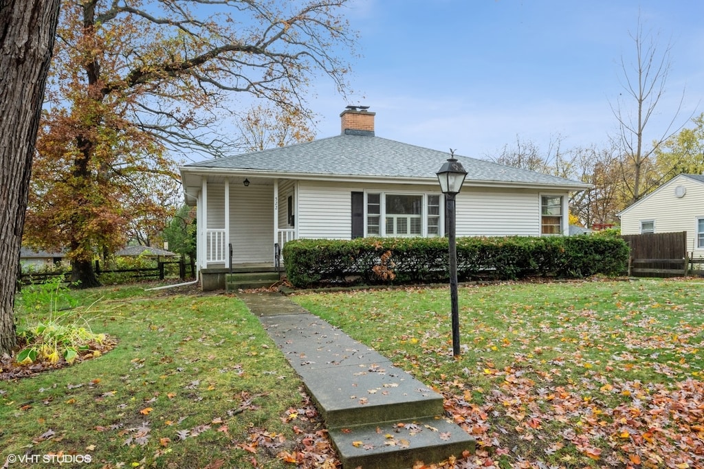 view of front of home featuring covered porch and a front yard