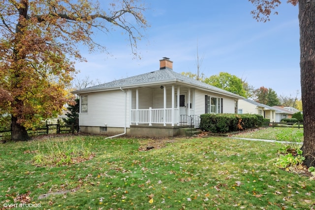 ranch-style home with covered porch and a front yard