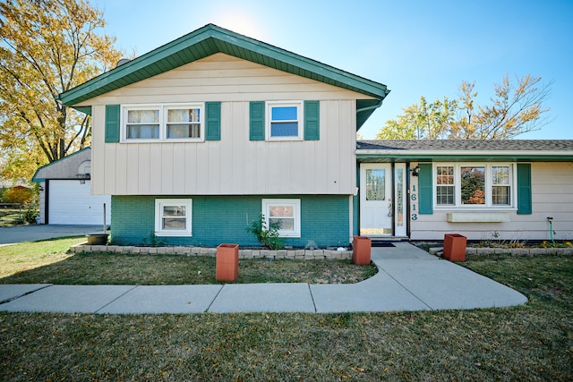 tri-level home with a front yard and a garage