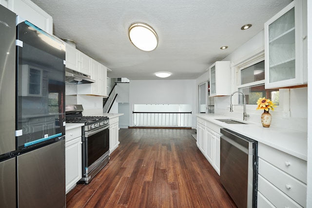 kitchen with sink, white cabinetry, stainless steel appliances, extractor fan, and dark hardwood / wood-style floors