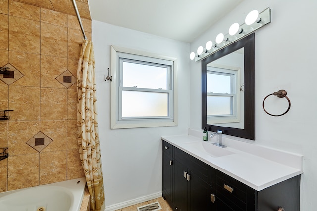 bathroom with vanity, shower / bath combo with shower curtain, and plenty of natural light