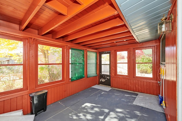 unfurnished sunroom featuring a wood stove