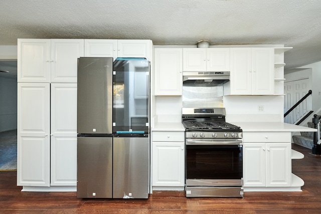 kitchen with appliances with stainless steel finishes, a textured ceiling, white cabinetry, and dark hardwood / wood-style flooring