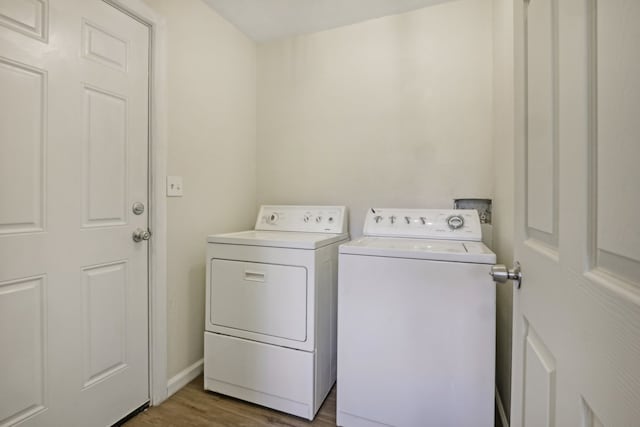 laundry area with hardwood / wood-style floors and washing machine and dryer