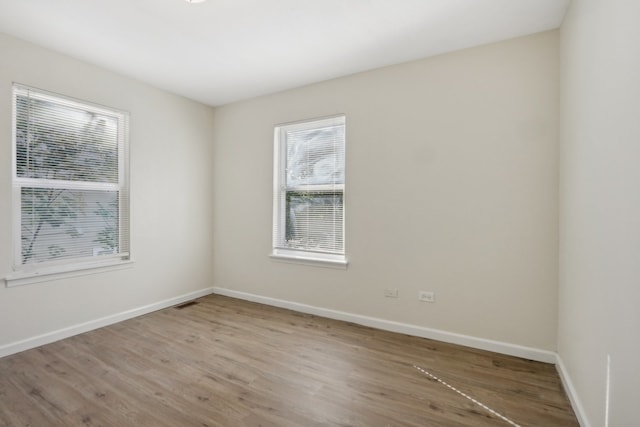 spare room featuring light hardwood / wood-style floors