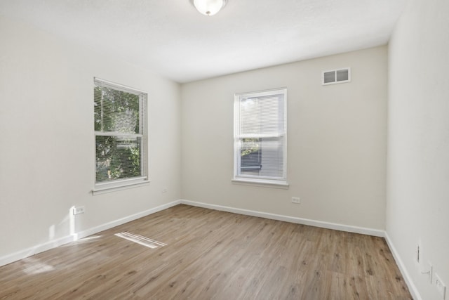 empty room with light hardwood / wood-style flooring