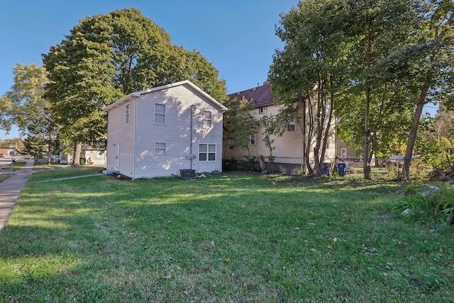 view of property exterior with a yard