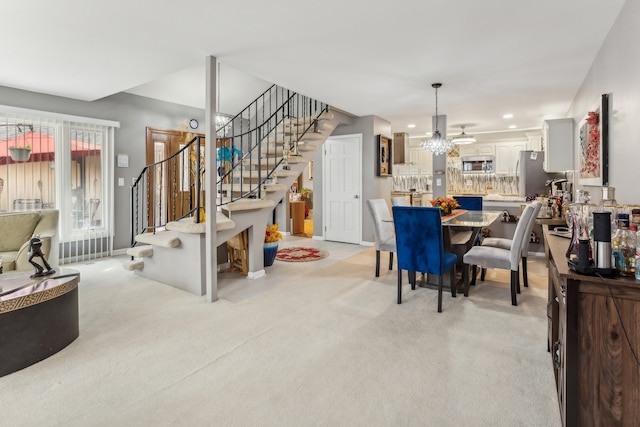 carpeted dining area featuring an inviting chandelier