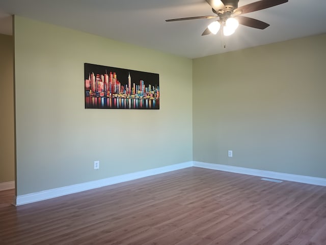 spare room featuring hardwood / wood-style floors and ceiling fan