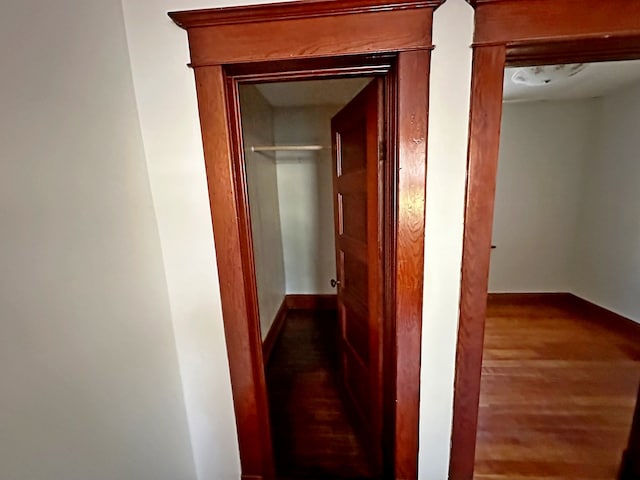 hallway with hardwood / wood-style floors