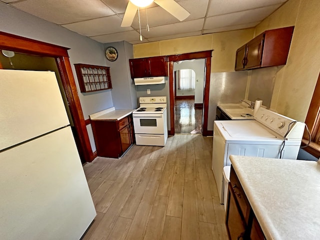 kitchen with white appliances, washer and dryer, sink, a paneled ceiling, and light hardwood / wood-style flooring