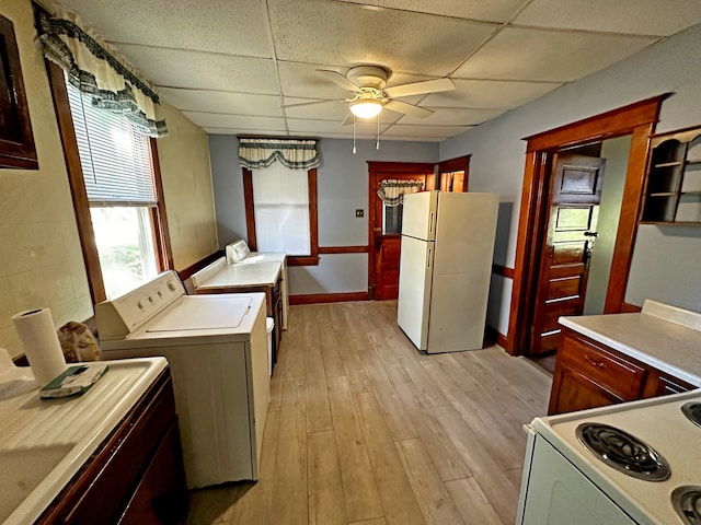 kitchen featuring ceiling fan, light wood-type flooring, independent washer and dryer, a drop ceiling, and white appliances