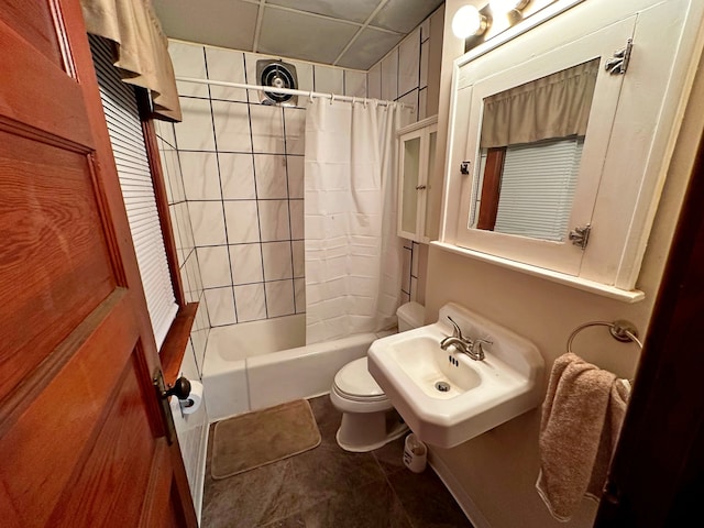 bathroom with tile patterned flooring, toilet, and shower / bath combo