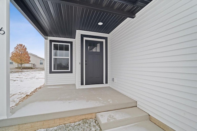 view of snow covered property entrance