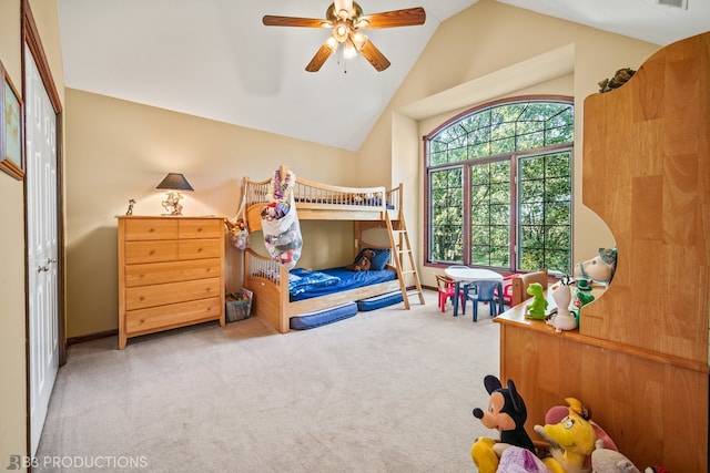 bedroom featuring a closet, vaulted ceiling, carpet, and ceiling fan