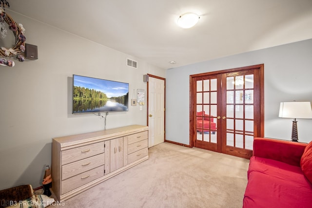 living room with french doors and light carpet