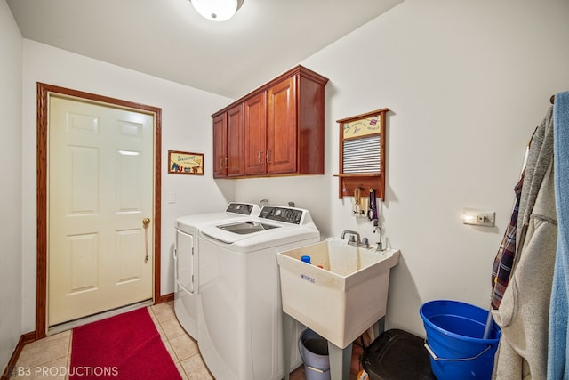 washroom featuring sink, light tile patterned floors, cabinets, and separate washer and dryer