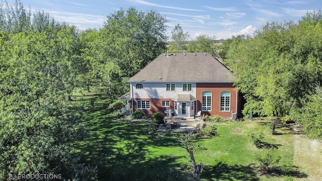 back of property featuring a patio and a lawn