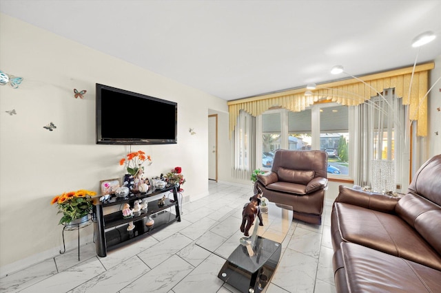 living room with marble finish floor and baseboards