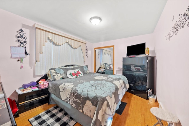 bedroom featuring wood finished floors and a closet